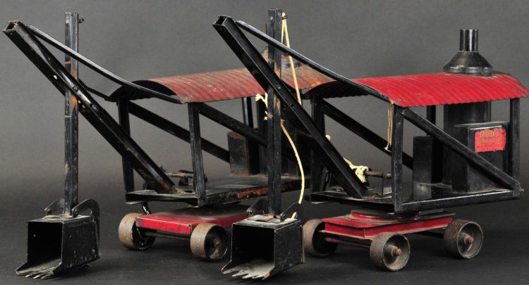 BUDDY 'L' STEAM SHOVELS: Early 1921-1923, pressed steel, vertical boiler on frame housing, red corrugated roof, easy pull on roller wheels, black scoop shovel, swivel base. 21" l.