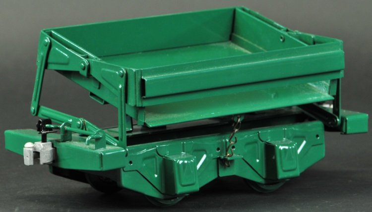 T-REPRODUCTION BUDDY 'L' SIDE DUMP CAR: Contemporary, outdoor railroad accessory, pressed steel, painted in green overall, side lifting supports. 10 1/2" l.