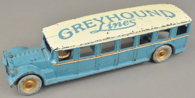 ARCADE GREYHOUND LINES BUS: Cast iron Fageol bus, done in blue and white overall, lettered Greyhound Lines on the roof, this is a repainted example. 12" l.