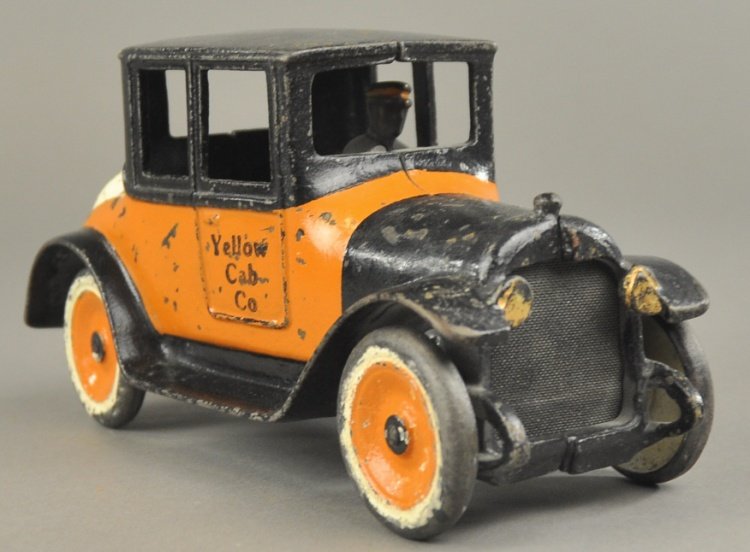 1922 DODGE COUPE: Arcade, cast iron, painted in orange and black color scheme, same as Arcade's Yellow Cabs with stenciling on door, painted disc wheels, features seated driver, spare mounted on rear, embossed "1922." 