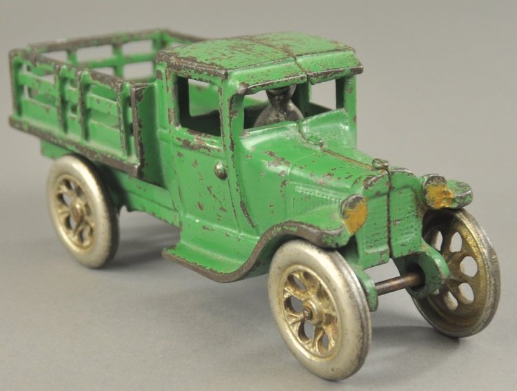FORD STAKE TRUCK: Arcade, late 1920's, cast iron, painted in green body, open stake side body, nickel driver and spoke wheels. 7 1/2" l.