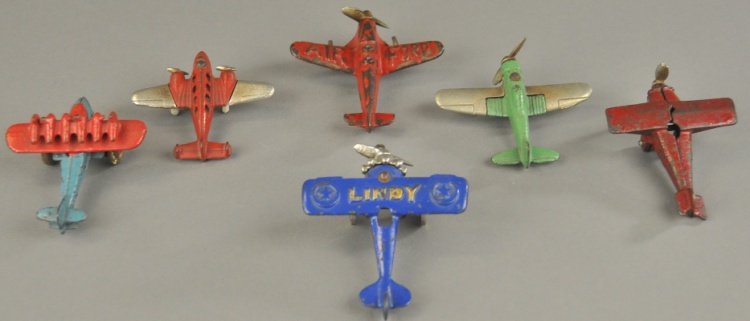 GROUPING OF SIX SMALL AIRPLANES: Fleet of cast iron airplanes includes: Hubley single and double engines, together with a Lindy, Air Ford, DO-X and Kilgore monoplane, varied colors. 3" - 4" l.