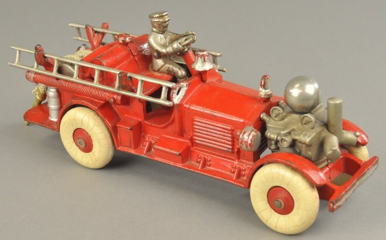 AHRENS FOX FIRE ENGINE: Hubley, cast iron, desirable fire toy, painted in red, features front mounted nickel pump, cast bell, nickel ladders on sides, seated original driver, rubber tires. 11" l.