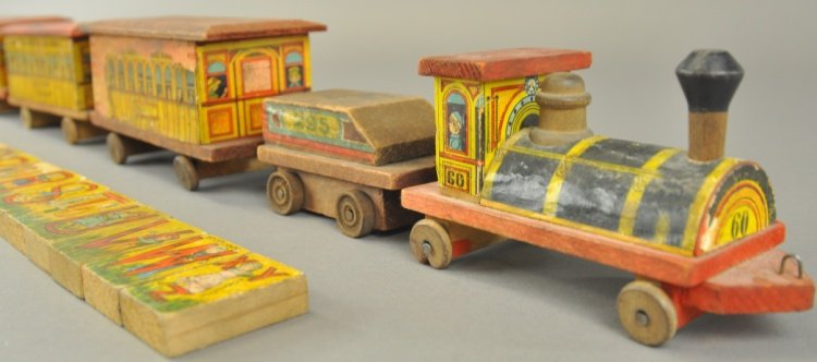 BLISS NEW YORK CENTRAL FLOOR TRAIN SET: Three piece Bliss train set includes locomotive and tender and three passenger cars, all in paper over wood lithography, includes twenty-one small blocks. Loco 5 1/4" l.