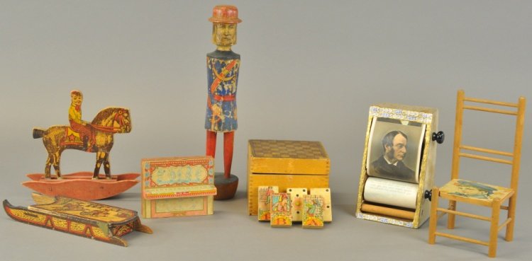 ASSORTED PAPER LITHO AND MISCELLANEOUS LOT: Varied grouping includes: wooden sleigh candy container, boy on rocking horse, miniature chair, author's scroll box, dominoes, paper over wood pins and one Ives soldier ten pin. 1" - 11 3/4" l.