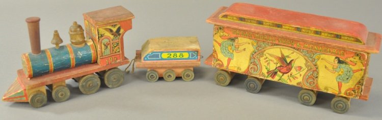 BLISS LOCOMOTIVE AND MENAGERIE TRAIN CAR: Paper over wood example, features Monkey conductor at 193 locomotive with 288 tender, together with interesting Great Moral Show and menagerie train car containing great graphics. Loco 7 1/2" l.