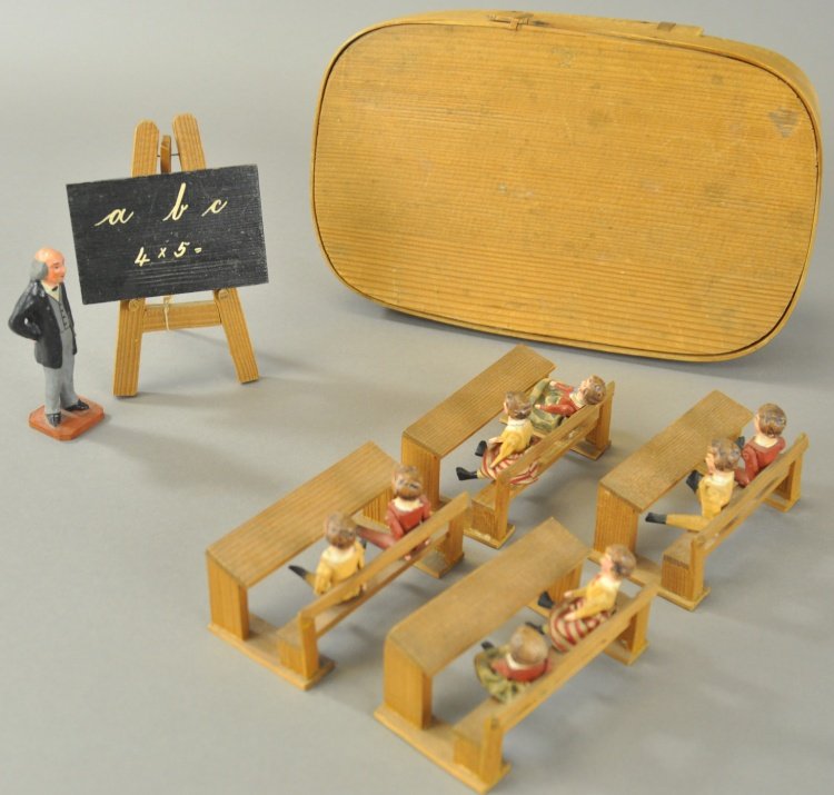 CHILDREN AT SCHOOL DISPLAY: Germany, Erzgebirge style wooden carved boxed set features children seated at desks with larger composition teacher figure and wooden blackboard on easel. Desk 1 1/4" h.