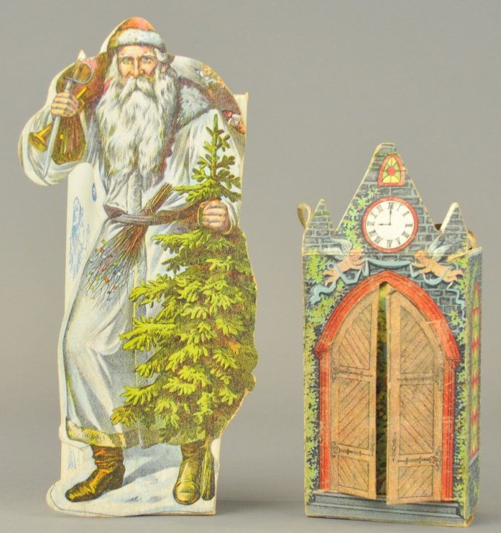 TWO CHRISTMAS CANDY BOXES: A tall Saint Nicholas, Christmas tree in hand, die-cut front box marked, "Sweets," and cathedral candy box, doors open to reveal a candle lit Christmas tree, instructions on box base for inserting can