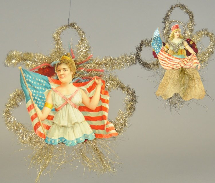 TWO PATRIOTIC CHRISTMAS TREE ORNAMENTS: Germany, die-cut scrap, girl with flag on wire tinsel, and "Miss Liberty" with flag, scrap on tinsel background. 6" - 8" l.
