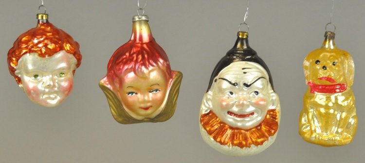 FOUR GLASS CHRISTMAS TREE ORNAMENTS: Includes a Joey clown head, sitting dog, angel bust, and boy's head, all from various time periods, still retaining original paint & strong colors. 2 1/2" - 3 1/2" l.