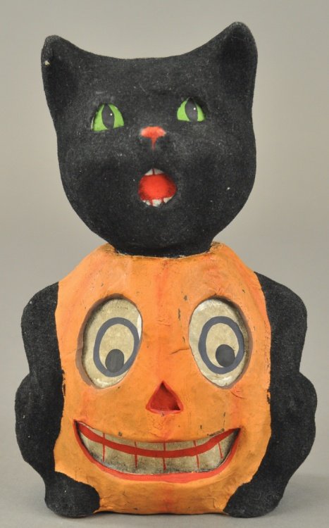 BLACK CAT/PUMPKIN HALLOWEEN CANDY CONTAINER: Post war piece, a Halloween pumpkin Jack-O-Lantern with paper face and the head of a black cat with black flocking covering its head, arms and tail, the cat's head separates from the pumpkin body. 8" 