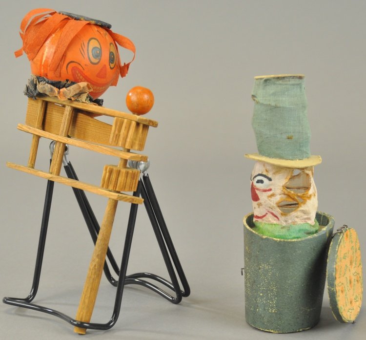 PUMPKIN HEAD NOISEMAKER & JACK-IN-THE-BOX: Germany, lithographed cardboard pumpkin head on wood cranking noisemaker, and cloth and spring vegetable man Jack-in-the-Box. 7" - 9" l.