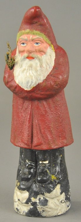 COMPOSITION BELSNICKLE ON SNOW MOUND: Germany, this dark red robe Santa stands on snow covered tree stump, holding a tree sprig in his crossed arms. 8 1/2" l.