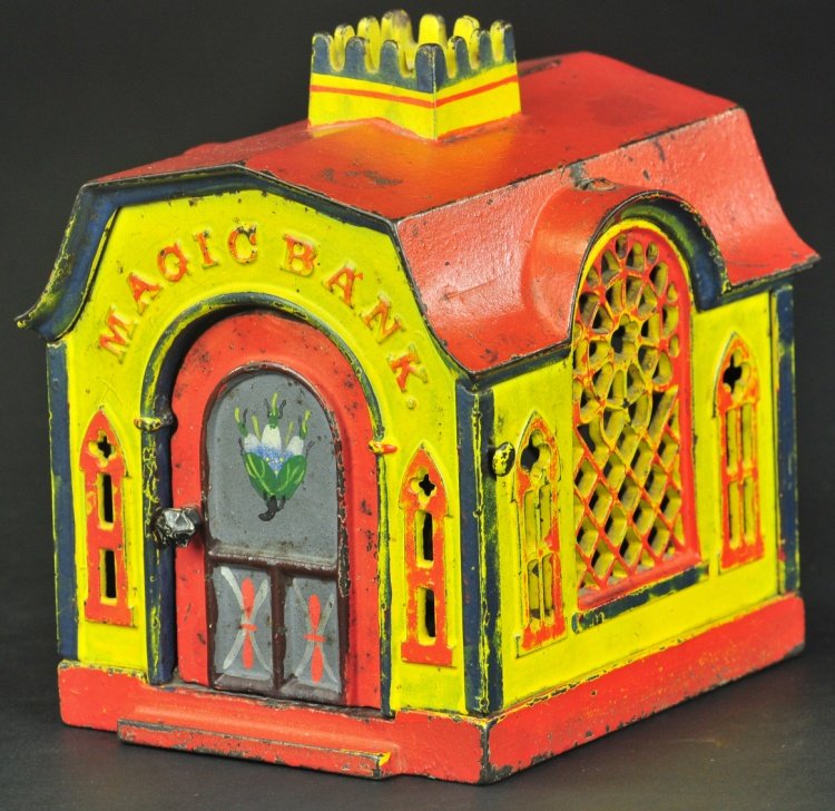 MAGIC MECHANICAL BANK: J. & E. Stevens Co., designed by Henry W. Prouty, Patented 1876, cast iron, yellow, red and blue trim building, coins can be deposited in roof slot, or by opening front door, placing on cashiers tray 