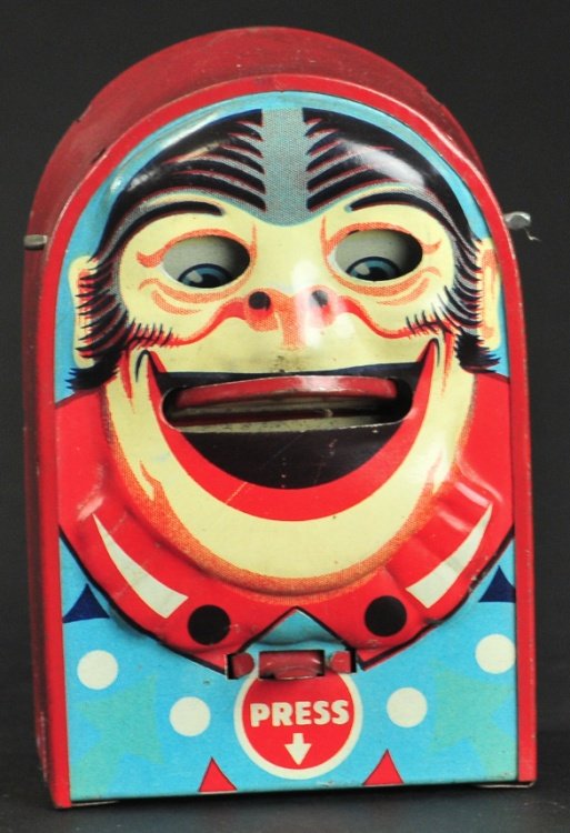 MONKEY FACE - ARCHED TOP TIN BANK: England, circa 1925, lithographed tin, colorful and whimsical, monkey sticks out tongue with lever and able to deposit into holder. 4 3/8" h.