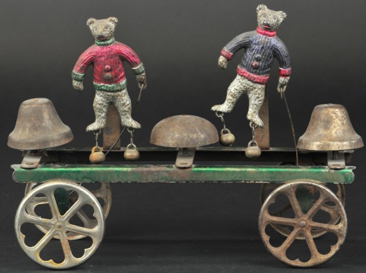 WATROUS BEAR RINGERS: An attractive toy, cast iron bears are spirit painted in red, silver, and green trim, flat strap platform contains three bells activated by articulated axles, bells appear on bear's feet. 10" l.