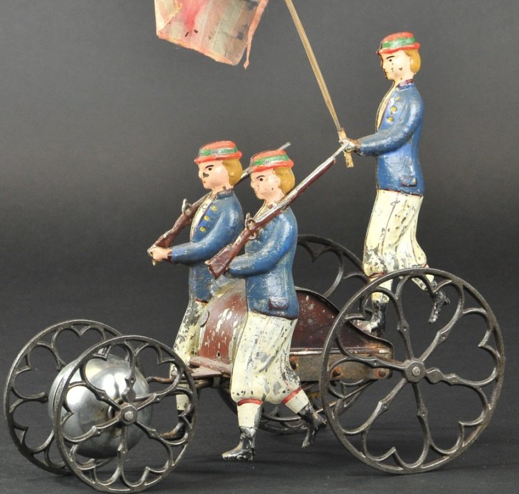ALTHOF BERGMANN PATRIOTIC MARCHING BELL TOY: circa 1874, hand painted tin example, clockwork mechanism housed at center of three figures clad in blue and white outfits, two march with rifles and center figure holds flag, cast iron spoke wheels a