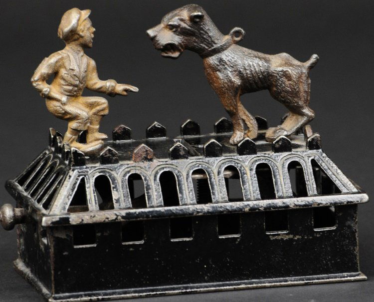 BOY AND BULL DOG MECHANICAL BANK: Judd Mfg. Co., CT, circa 1880's, cast iron, black painted base, japanned dog, lever action allows boy to lean forward and deposit coin into slot as dog moves backwards.