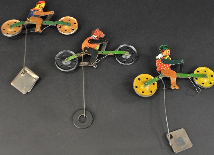 A. C. GILBERT BOY, GIRL AND BEAR STRING TOYS: Articulated lithographed tin figures with counterweights allowing a balanced string travel. 6 1/4" l.
