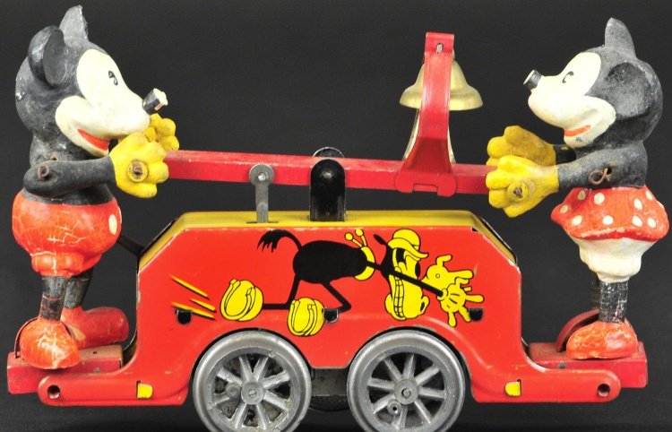 MICKEY MOUSE HAND CAR: Wells-O-London, England, features lithographed tin red body hand car with hand painted composition figures of Mickey and Minnie at each end. 8" l.