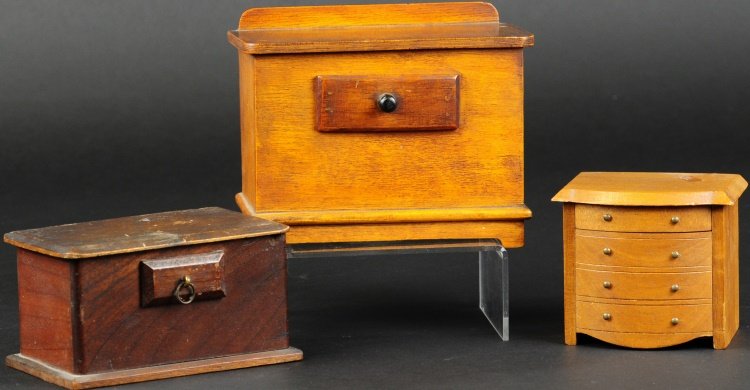 LOT OF THREE WOODEN BANKS: Each with trick drawer for coin deposit, one shaped as hope chest, and two in form of dressers. Provenance: Edwin H. Mosler Jr. Collection. 3 1/2" to 5 1/4" h.