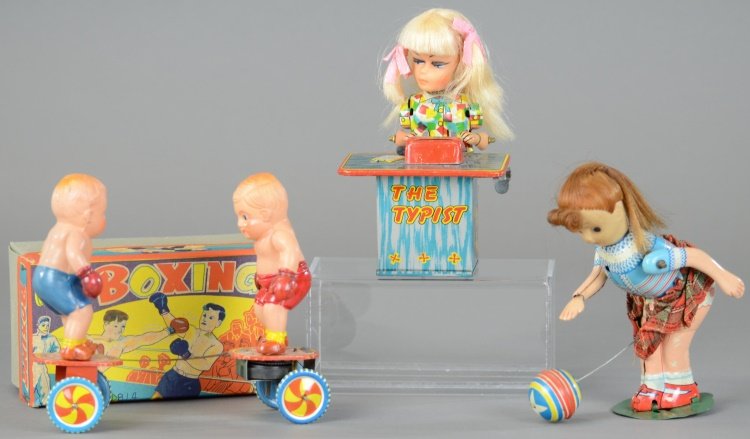 GROUPING OF TIN WIND-UP TOYS: Japan, assorted lot includes: Girl at typewriter, Girl bouncing ball, and boxed celluloid Boxers toy, all with wind-up action. 3 1/2" - 6" h.