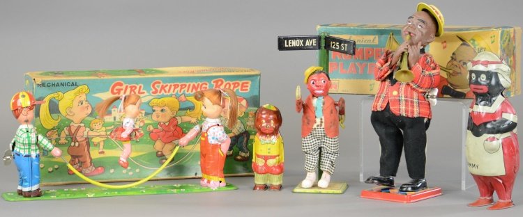 TIN WIND-UP TOY LOT: Varied examples includes: T.P.S. Girl Skipping Rope in box, litho tin Waddling Child figure toy, Lindstrom Mammy Waddler, boxed Louis Armstrong look-alike Trumpet Player, and dancing celluloid Minstre