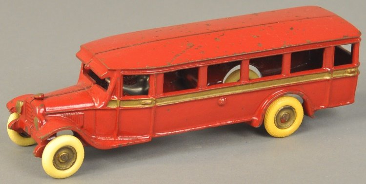 ARCADE PARLOR COACH: circa late 1920's, cast iron example painted in red body overall with gold side band, features seated nickel driver and disc wheels. Ex. Don Kaufman Collection. 9 1/2" l.