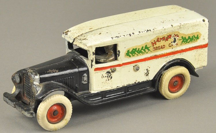 ARCADE "HATHAWAYS" BAKERY DELIVERY TRUCK: Popular example, cast iron panel truck painted in white and black overall, colorful bakery logo on sides, seated nickel driver, rubber tires, disc wheels, Arcade decal on back door. 9 1/2" l.