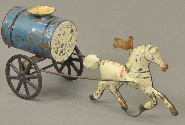 HORSE DRAWN WATER TANKER: George Brown, hand painted tin, blue tank body drawn by white solo horse posed with tin flag on its back, spoke wheels carry tanker. 7" l.