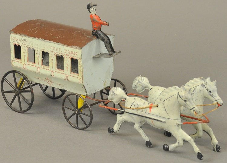 GEORGE BROWN BROADWAY OMNIBUS: Rare example, hand painted tin and stenciled, features seated driver at rooftop and drawn by two white horses, arch style windows on each side and lettered, "Broadway & Central Park" in light maroon, 