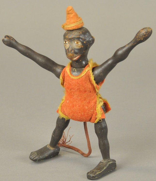 SCHOENHUT MONKEY: All wooden jointed construction, dark face, depicts standing circus monkey in felt jumpsuit with yellow fringe and felt hat, rope tail. 8" h.