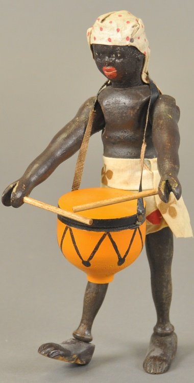 SCHOENHUT TEDDY SAFARI AFRICAN NATIVE FIGURE: Wood jointed, two part head, closed mouth, wearing khaki shorts, sash and turban, holding drumstick and drum, very rare. 8 1/2" h.