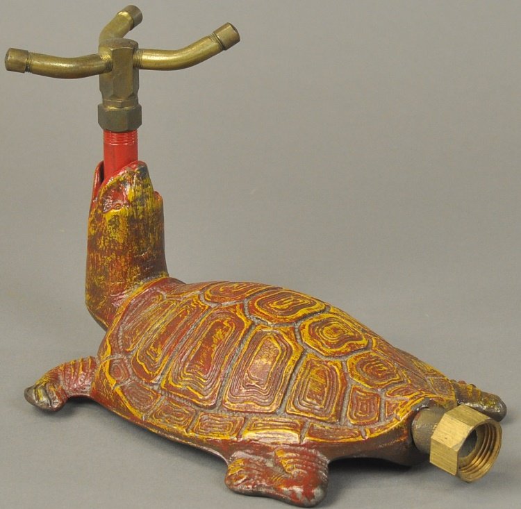 TURTLE LAWN SPRINKLER: Figural cast iron example, well cast ornamental and functional lawn sprinkler depicted in red and yellow colors. 10" l.
