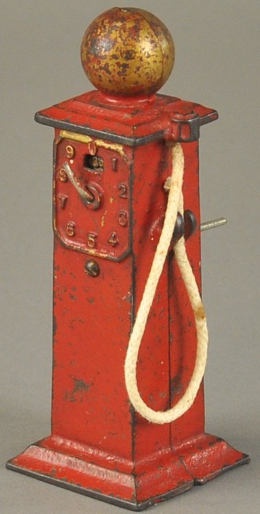 GAS PUMP STILL BANK: Arcade, cast iron, painted in red overall, gold globe, hose attached to side. 5 3/4" x 2 1/4".