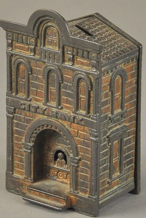 CITY BANK WITH TELLER STILL BANK: H. L. Judd Mfg. Co., cast iron, bronze finish overall, detailed casting depicts seated teller inset from front steps. 5 1/2" h.