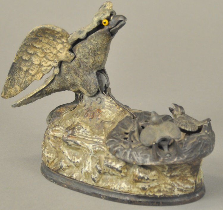 EAGLE & EAGLETS MECHANICAL BANK: J. & E. Stevens Co., designed by Charles M. Henn, Chicago, IL, Patented 1/23/1883, place a coin in the eagle's beak, press the lever and the eagletts rise from the nest, actually crying for food. As t