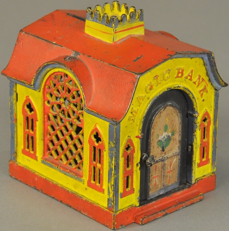 MAGIC MECHANICAL BANK: Yellow with red roof, J. & E. Stevens Co., designed by Henry W. Prouty, Patented 1886, after the door is opened, which brings the cashier to the front, a slight touch on a knob at the side causes him 