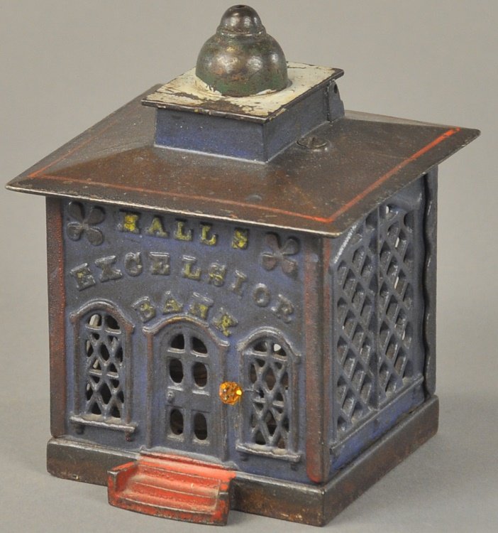 HALLS EXCELSIOR MECHANICAL BANK: Blue version, J. & E. Stevens Co., designed by John D. Hall, Patented 12/21/1869, on pulling a knob, a door opens at the top of this bank, and a figure of a cashier appears to receive the deposit, whe