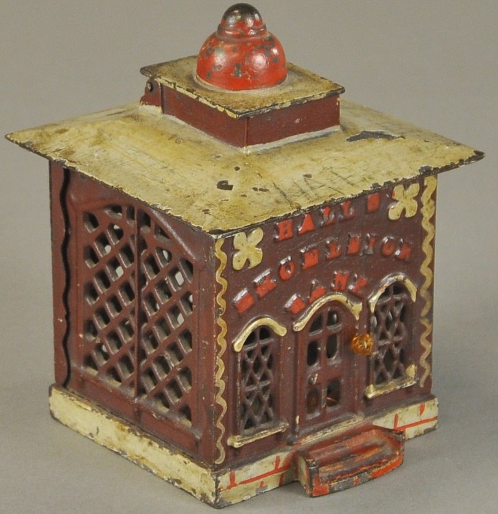 HALLS EXCELSIOR MECHANICAL BANK: J. & E. Stevens Co., designed by John D. Hall, Patented 1869, red and grey, when pulling knob, a door opens at the top of this bank, a cashier figure appears to receive the deposit, when this is made,