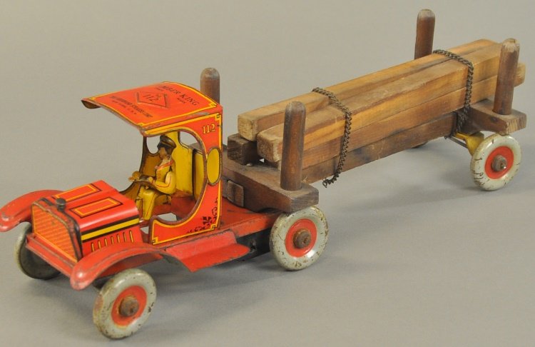 STRAUSS TIMBER KING TRUCK: Lithographed tin, red cab with wood trailer, as used by the logging trade, keywind operated, seated driver. 18" l.