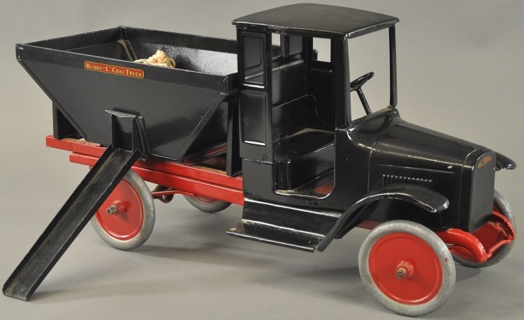 BUDDY 'L' COAL TRUCK: c. 1925, pressed steel toy truck, decals on body, hopper style body has opening side chute, painted in black overall, aluminum disc wheels. 24 1/2" l.