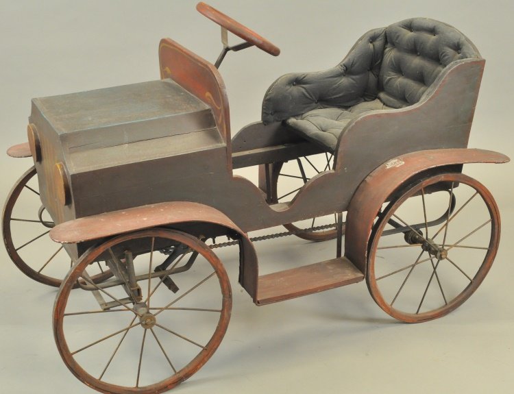 OPEN TOURER PEDAL CAR: Wooden example with chain drive pedal power, restored overall, upholstered seating, spoke wheels, tin fenders, dummy lights, great look overall. 46" overall length.[Oversized freight required]