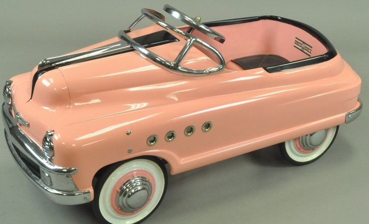 MURRAY TORPEDO PEDAL CAR: circa 1950's, Buick model pedal car, professionally restored and done in striking pink body color with nickel appointments and black hood trim. 36" l.