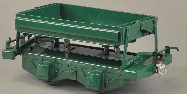T-REPRODUCTION BUDDY 'L' SIDE DUMP CAR: Contemporary, outdoor railroad accessory, pressed steel, painted in green overall, side lifting supports. 10 1/2" l.