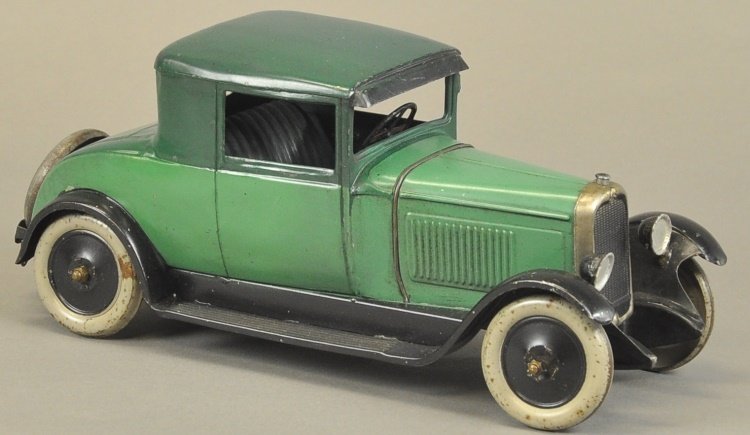 CITROEN FAUX CABRIOLET: France, circa 1928, light and dark green body colors make a nice color scheme, a classic toy which features opening doors, spare on trunk, nickel plated grille, embossed seating, clockwork driven. 12"