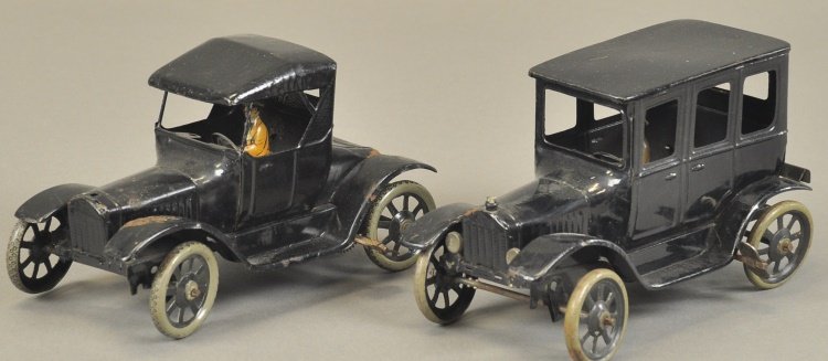 BING MODEL 'T' TOURING CAR AND SEDAN: Germany, black tin examples, two door model with seated lady driver, and four door with gentleman driver, spoke wheels, both clockwork driven. 6 1/2" l.