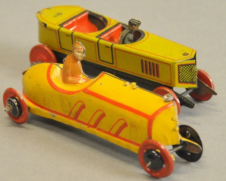 LOT OF TWO BOAT TAIL RACER PENNY TOYS: Germany, both lithographed tin with solo rider, larger done in yellow and gold trim, smaller mustard yellow and red and blue pin stripes. 4" l.
