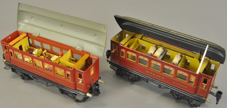 MARKLIN MITROPA SLEEPING AND DINING CARS: Germany, 'O' gauge examples, lithographed tin in red bodies, opening green roofs, full interiors. 8 1/4" l.