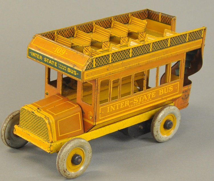 STRAUSS INTERSTATE DOUBLE DECKER BUS: Lithographed tin, brown version, bench seating on rooftop, disc wheels, clockwork driven, railing at rear entrance. 10 1/2" l.